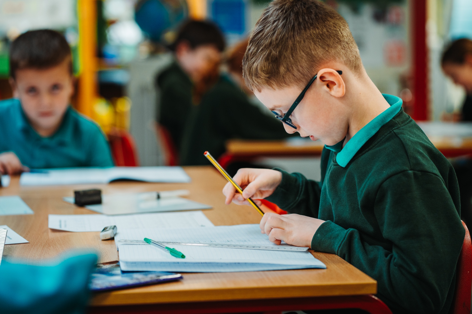 child working at classroom table
